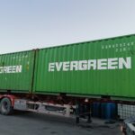 Green Evergreen shipping containers loaded on a freight truck, part of Eapearl Chem's delivery fleet.