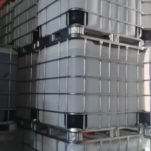 Stacked industrial intermediate bulk containers (IBCs) in a warehouse.