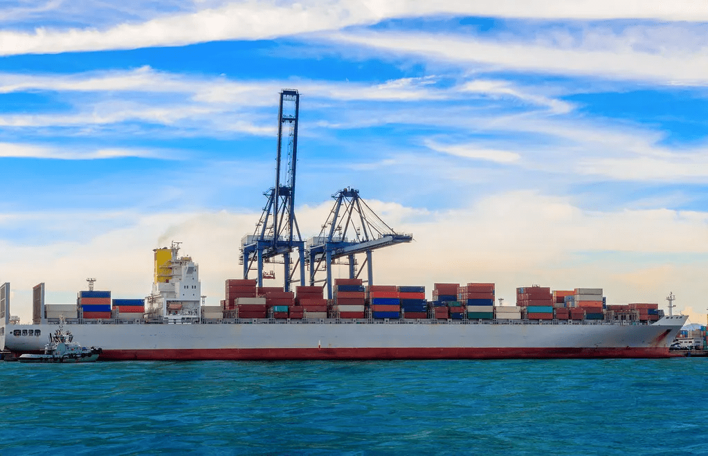 Container ship loaded with cargo at a commercial dock.