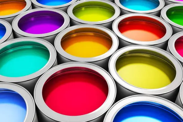 Multiple open paint cans with vibrant, assorted colors.