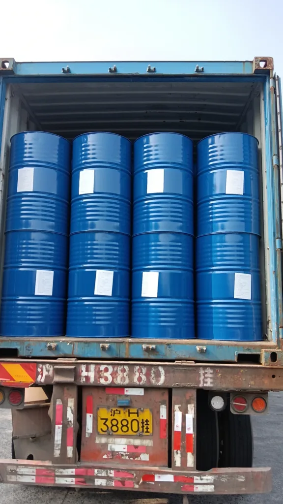 Delivery truck loaded with blue industrial chemical drums labeled Eapearl Chem.