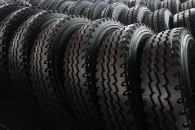 Row of stacked rubber tires highlighting the use in dye and rubber chemicals manufacturing.