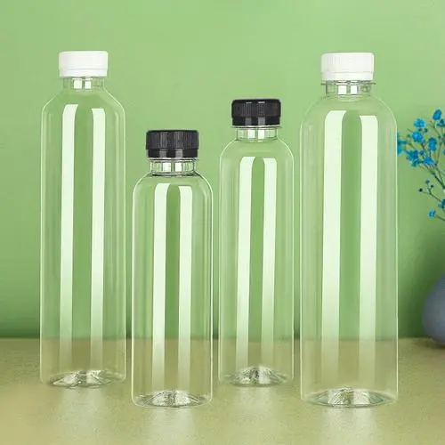 Transparent plastic beverage bottles with white and black caps on a green background, showcasing packaging options.