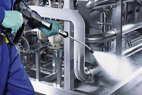 Professional cleaning industrial machinery using MEK-based solvent for efficient degreasing.